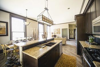A kitchen with a large island and a dining table.